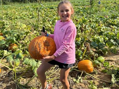 girl holding pumpkin
