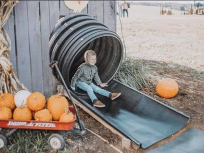 child coming out the end of an enclosed slide
