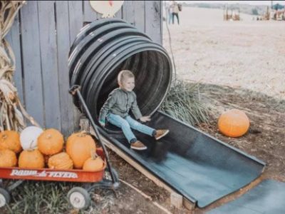 child coming out the end of an enclosed slide